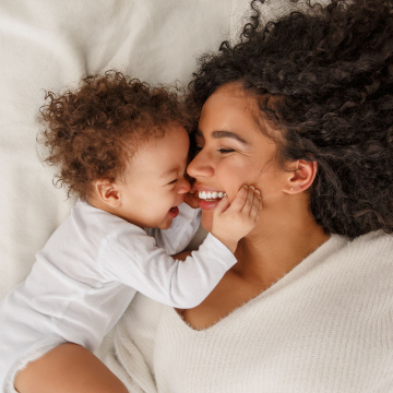 A mother and baby smile at each other