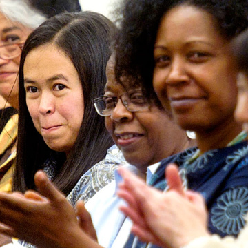 A group attending a workshop claps in unity