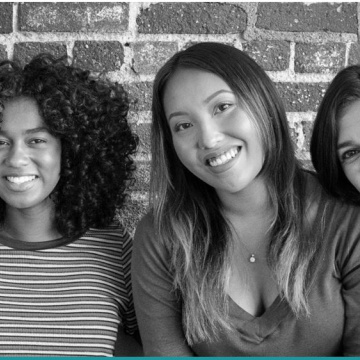 Black and white photo of three women smiling