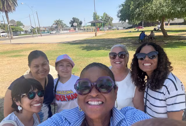 A group portrait of Cultiva La Salud, Health Affairs, Foundation staff, and RocQuel Johnson